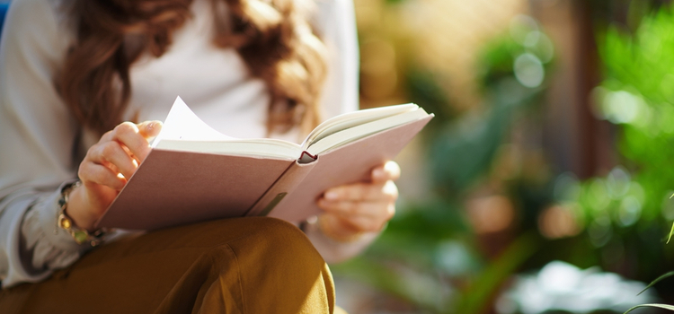 Close-up of a woman reading a book
