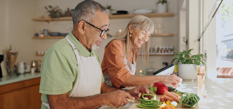 A couple cooking a meal together.